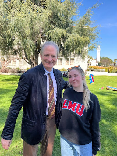 Dean Fox, tall man with white hair, standing next to student who is shorter with blonde hair